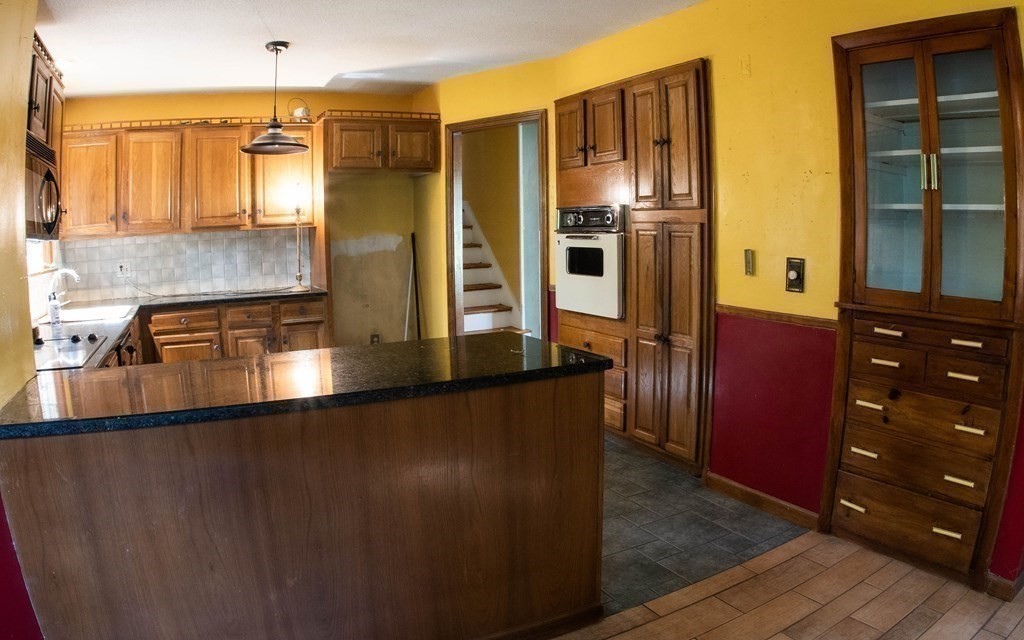 47 Craig Street Springfield, MA 01108 - Photo 8 of 18 a kitchen with stainless steel appliances granite countertop a refrigerator and a sink