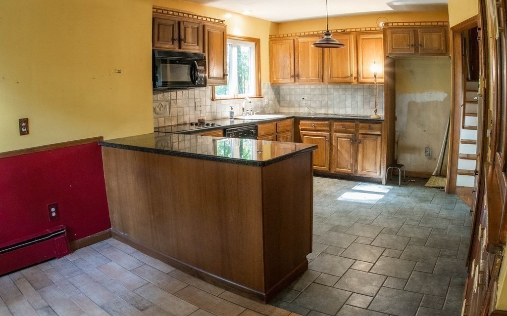47 Craig Street Springfield, MA 01108 - Photo 9 of 18 a kitchen with stainless steel appliances granite countertop a sink a stove and a refrigerator