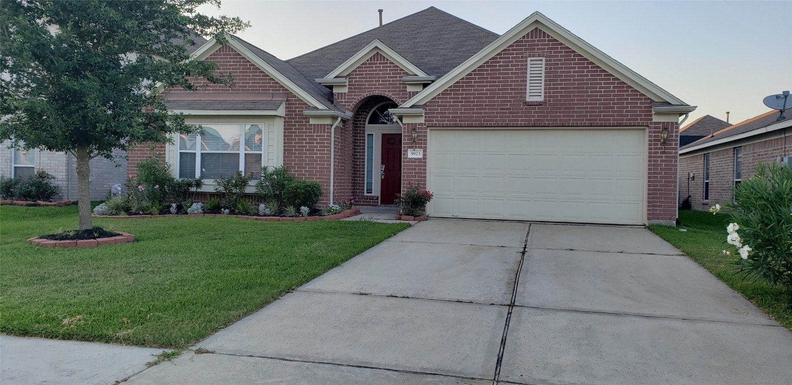 a front view of a house with a garden and plants