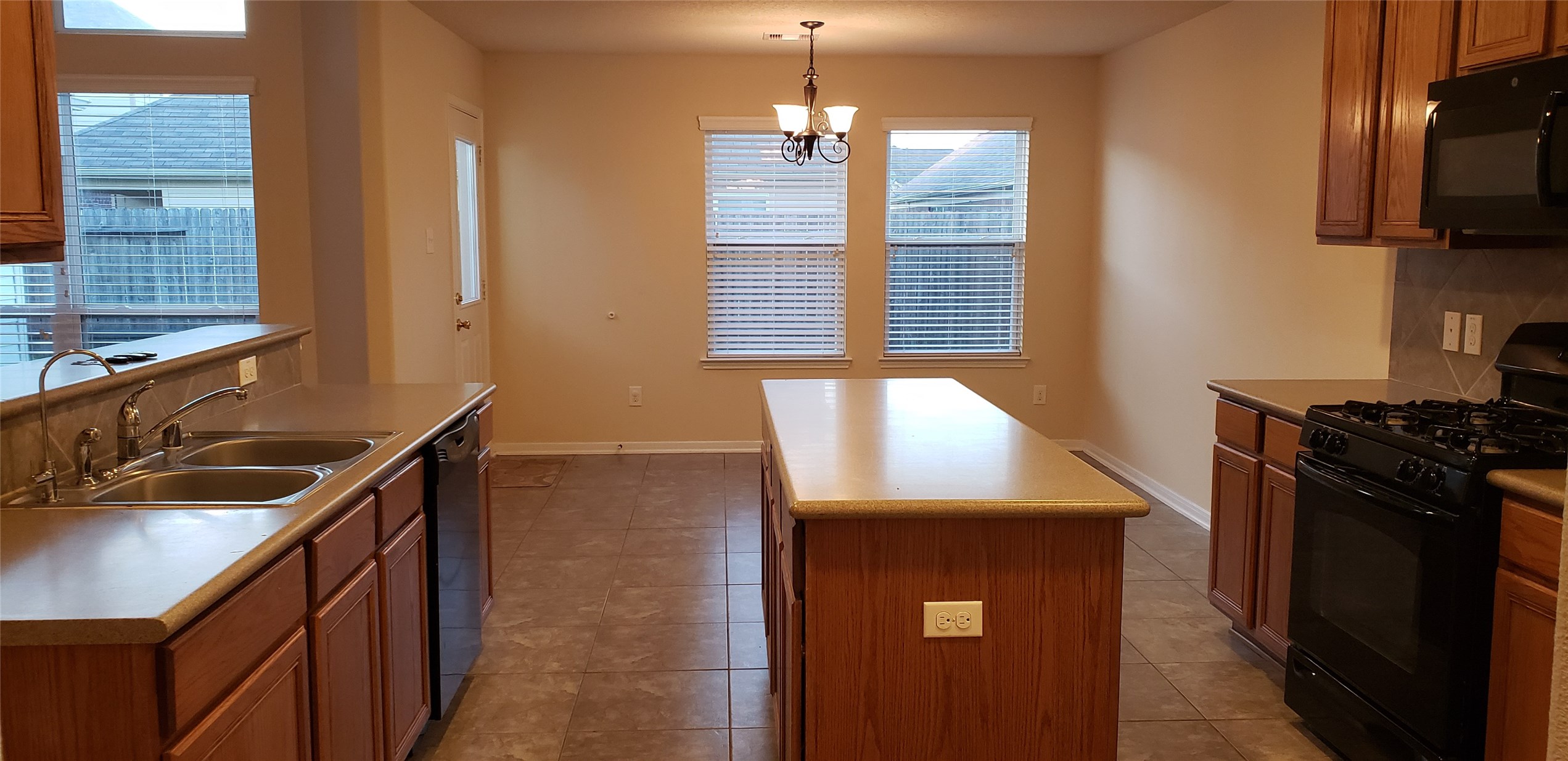 9923 Yearling Place Conroe, TX 77385 - Photo 2 of 36 a kitchen with a sink and a stove