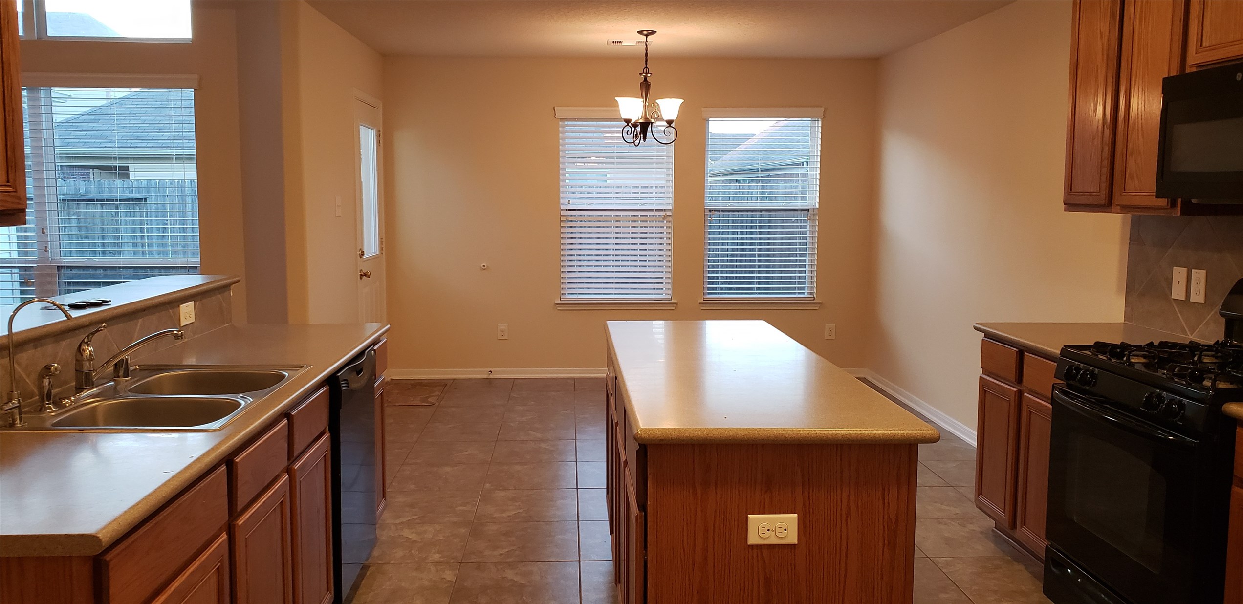 9923 Yearling Place Conroe, TX 77385 - Photo 3 of 36 a kitchen with a sink and a stove