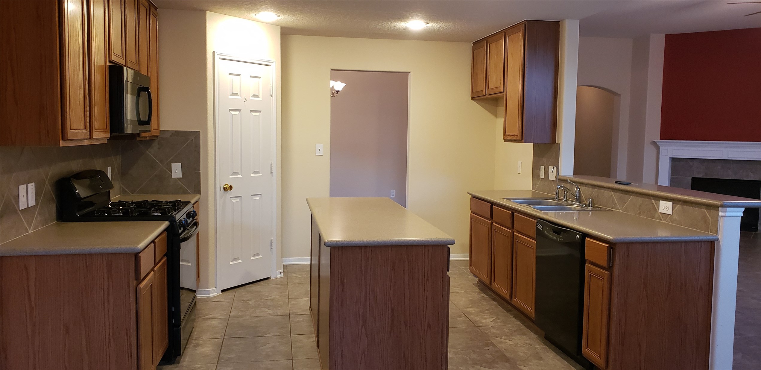 9923 Yearling Place Conroe, TX 77385 - Photo 6 of 36 a kitchen with stainless steel appliances granite countertop a sink stove and refrigerator