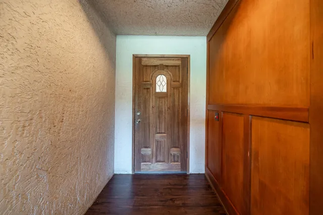 a view of a kitchen with wooden floor and a ceiling fan