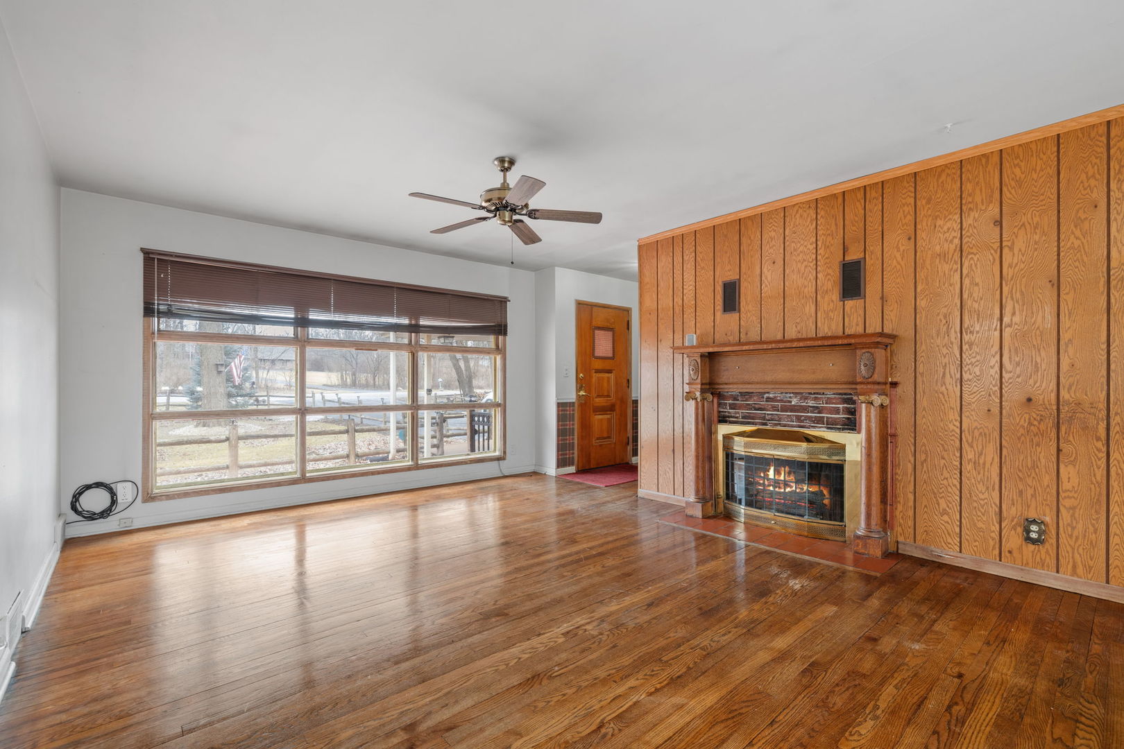 11040 Cleveland Road Mokena, IL 60448 - Photo 17 of 28 a view of an empty room with a fireplace and a window