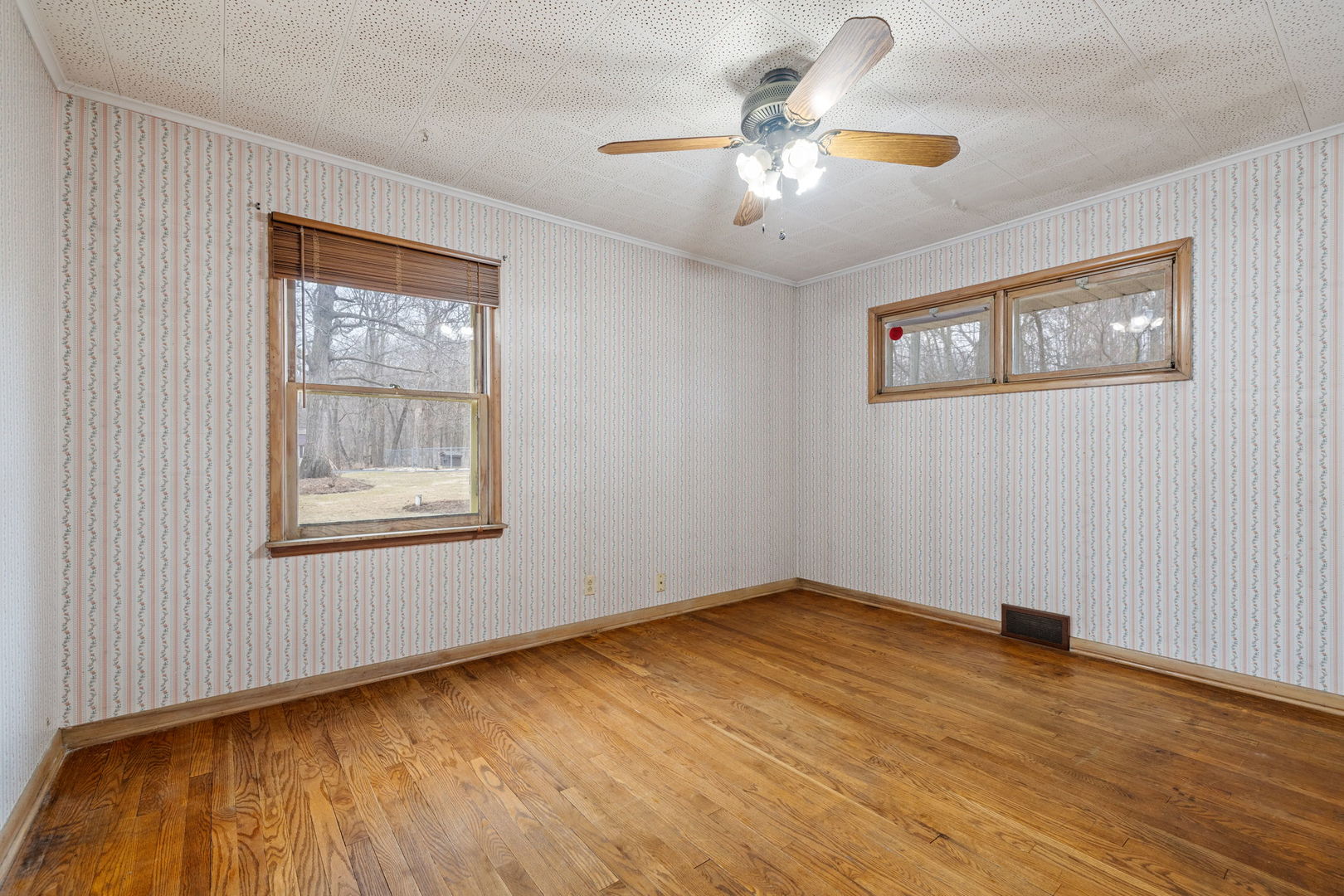 11040 Cleveland Road Mokena, IL 60448 - Photo 21 of 28 a view of an empty room with chandelier fan and wooden floor