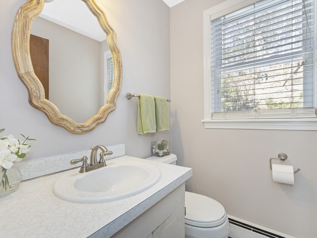 223 Hardy Pond Road Waltham, MA 02451 - Photo 19 of 38 a bathroom with a toilet sink and mirror