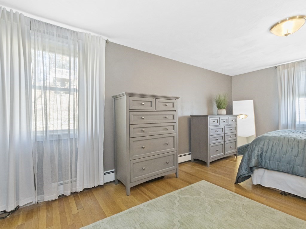 223 Hardy Pond Road Waltham, MA 02451 - Photo 23 of 38 a bedroom with a chair and a dresser
