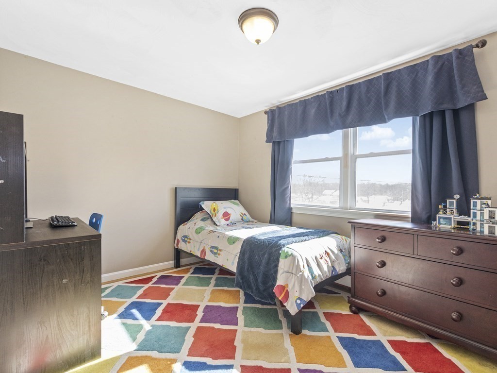 223 Hardy Pond Road Waltham, MA 02451 - Photo 24 of 38 a bedroom with a bed and a window