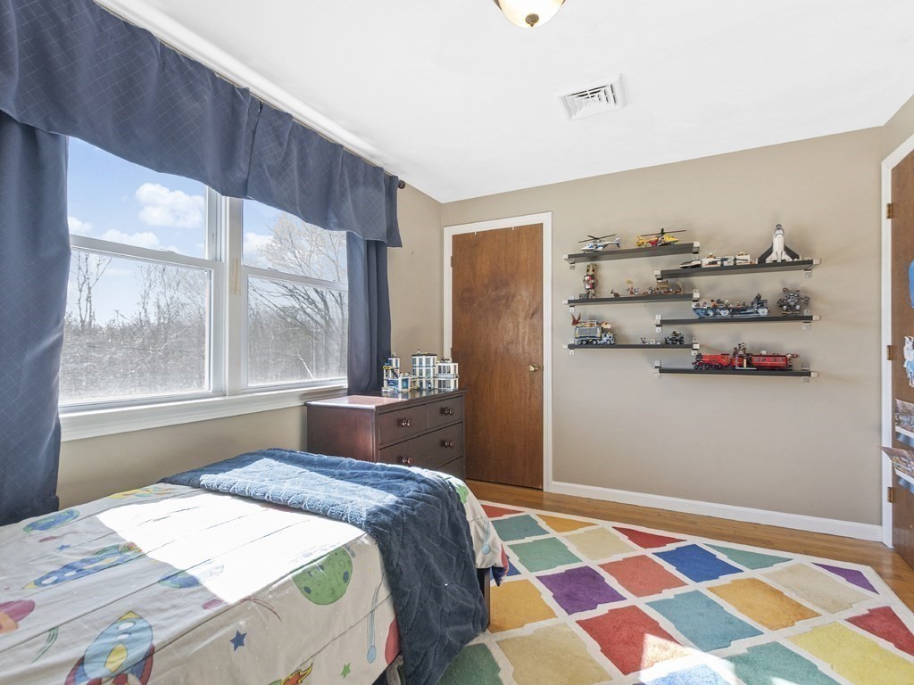 223 Hardy Pond Road Waltham, MA 02451 - Photo 25 of 38 a bedroom with a bed and a window