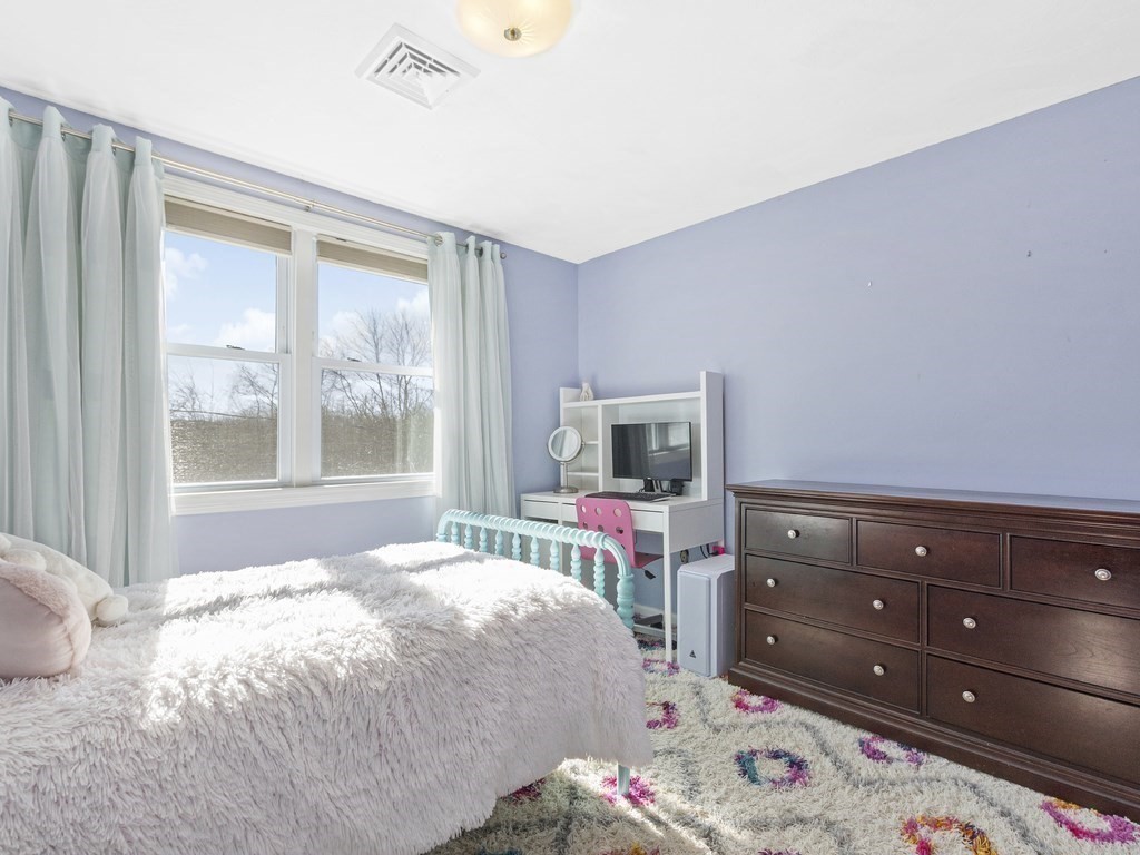 223 Hardy Pond Road Waltham, MA 02451 - Photo 27 of 38 a bedroom with a bed and a dresser in it