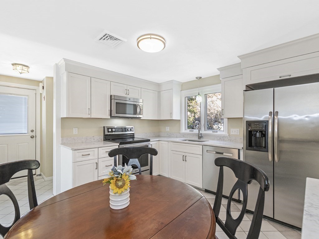 223 Hardy Pond Road Waltham, MA 02451 - Photo 3 of 38 a kitchen with a table and chairs in it