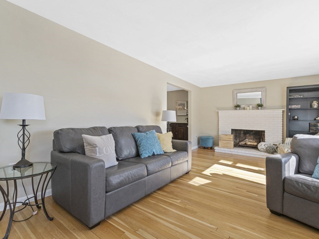 223 Hardy Pond Road Waltham, MA 02451 - Photo 8 of 38 a living room with furniture and a fireplace