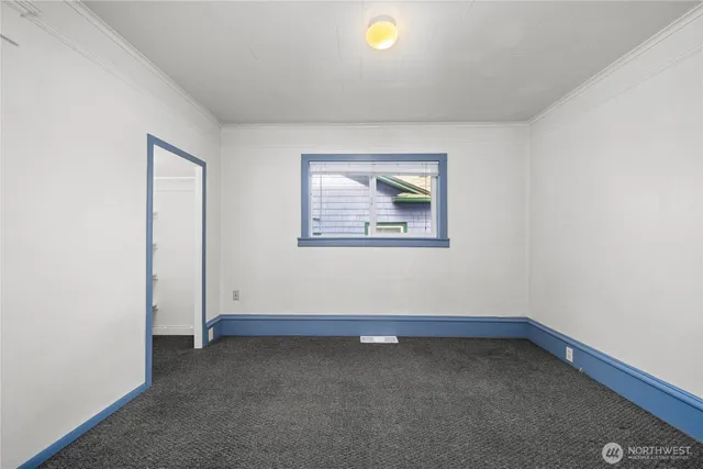 a view of an empty room and closet area