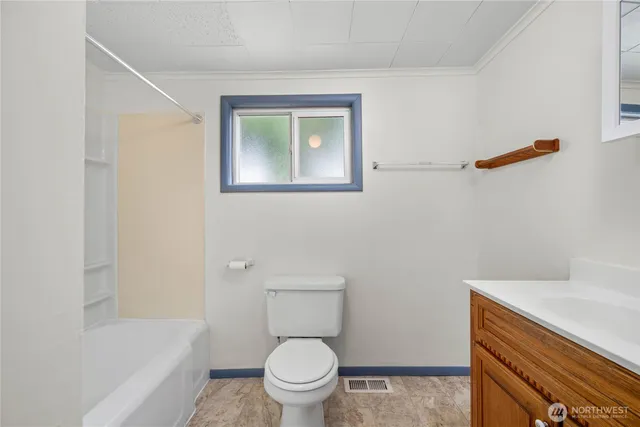 a view of bathroom with a sink and a window