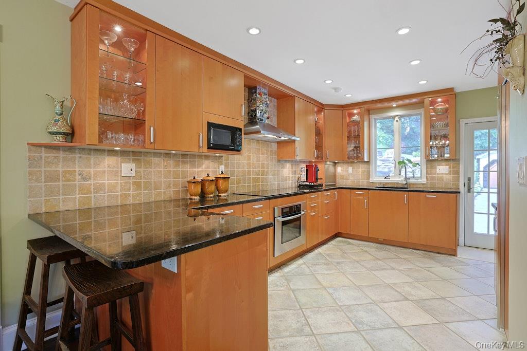 97 Underhill Road Scarsdale, NY 10583 - Photo 6 of 39 a kitchen with stainless steel appliances granite countertop a sink and cabinets