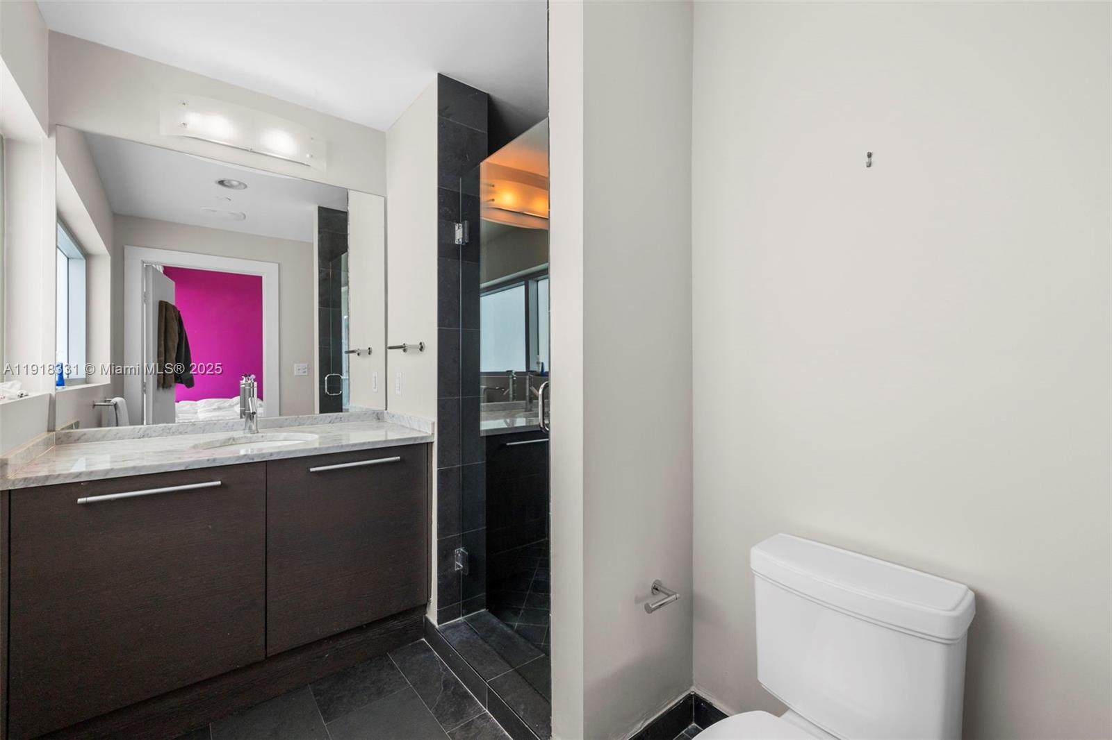 900 Biscayne Boulevard, Unit 2401 Miami, FL 33132 - Photo 11 of 33 a bathroom with a sink and a mirror