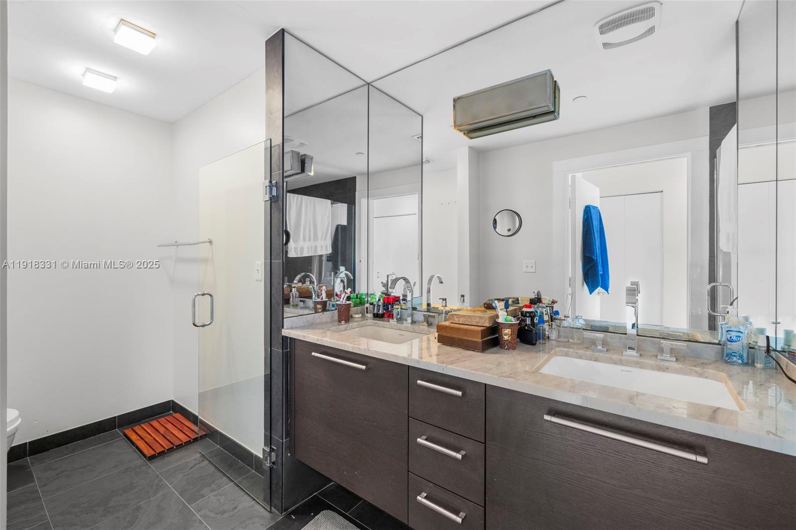 900 Biscayne Boulevard, Unit 2401 Miami, FL 33132 - Photo 18 of 33 a bathroom with a double vanity sink and a mirror