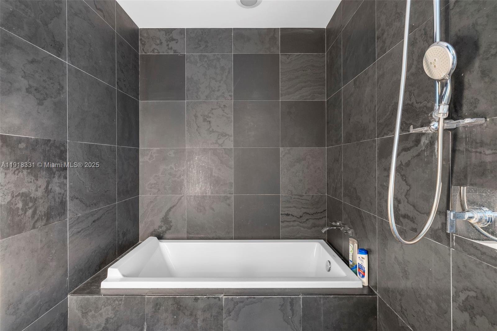 900 Biscayne Boulevard, Unit 2401 Miami, FL 33132 - Photo 19 of 33 a bathroom with a bath tub and white shower