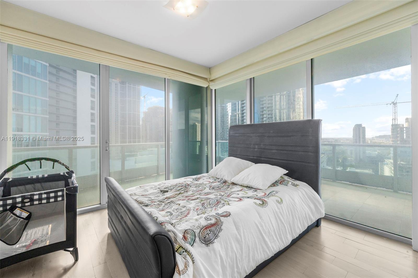 900 Biscayne Boulevard, Unit 2401 Miami, FL 33132 - Photo 20 of 33 a bedroom with a bed and a fireplace