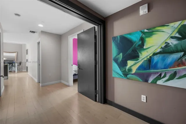 a view of a livingroom with wooden floor and furniture