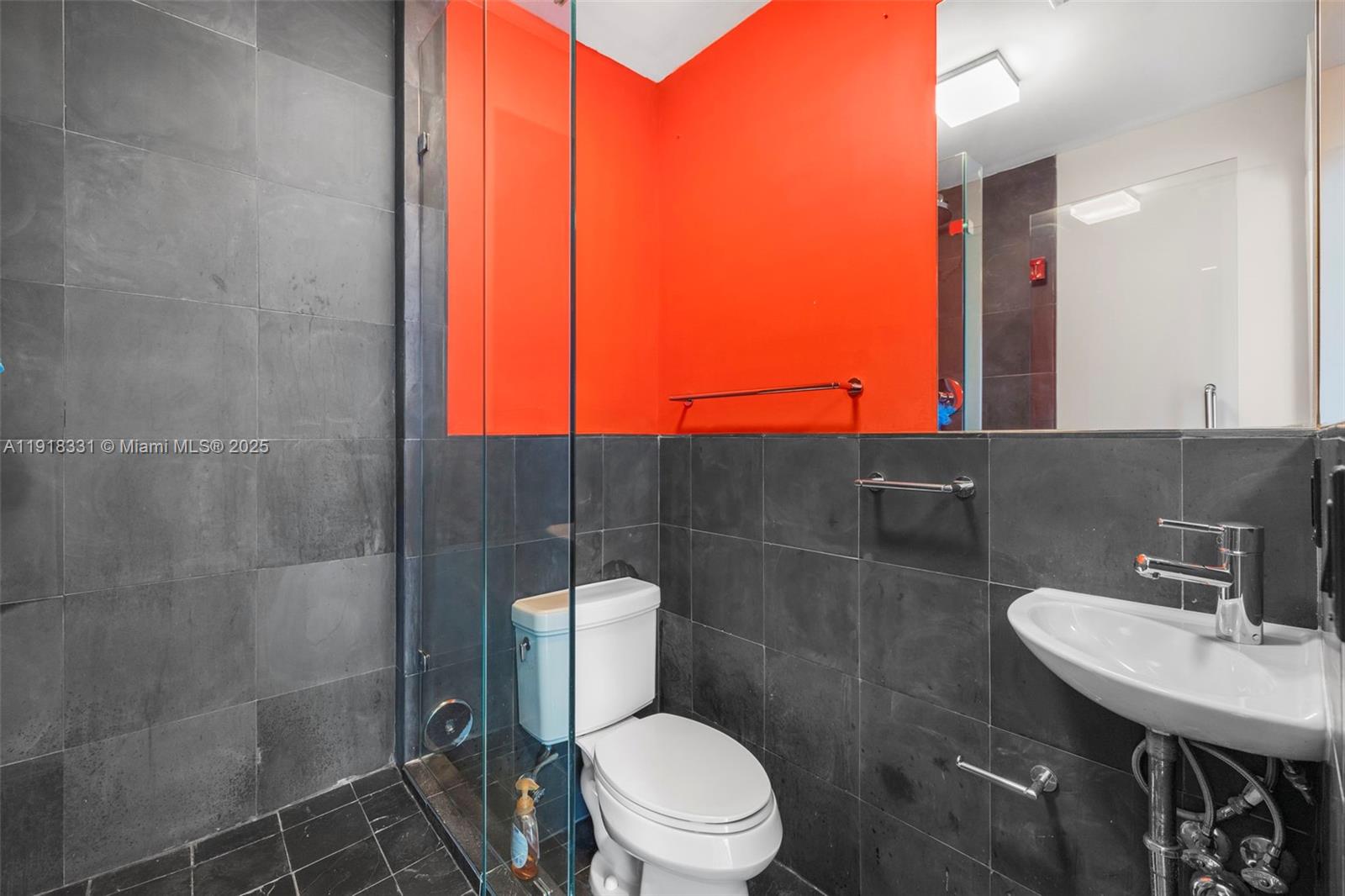 900 Biscayne Boulevard, Unit 2401 Miami, FL 33132 - Photo 9 of 33 a bathroom with a toilet a sink and mirror