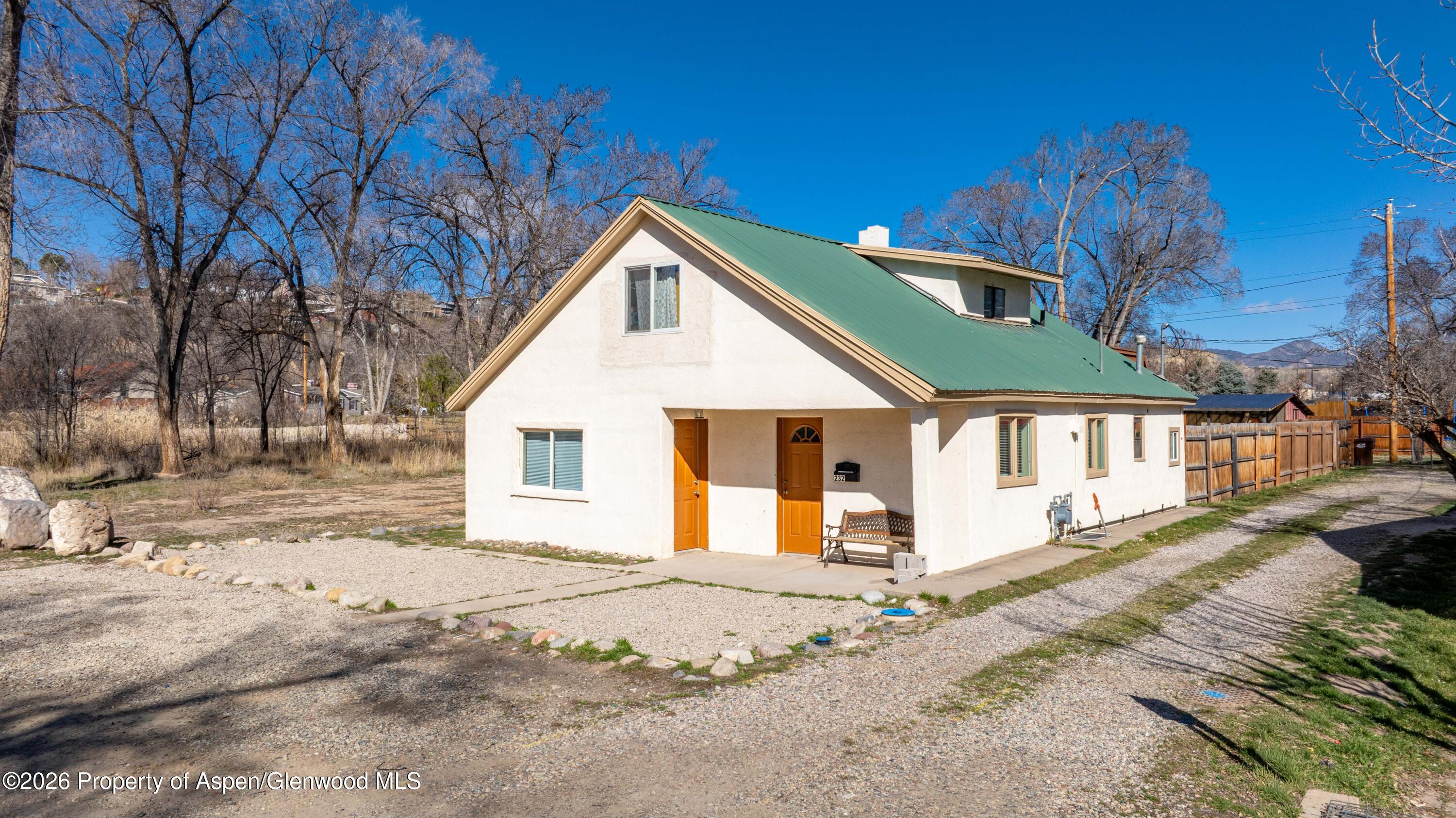 a view of a white house with a yard covered in snow