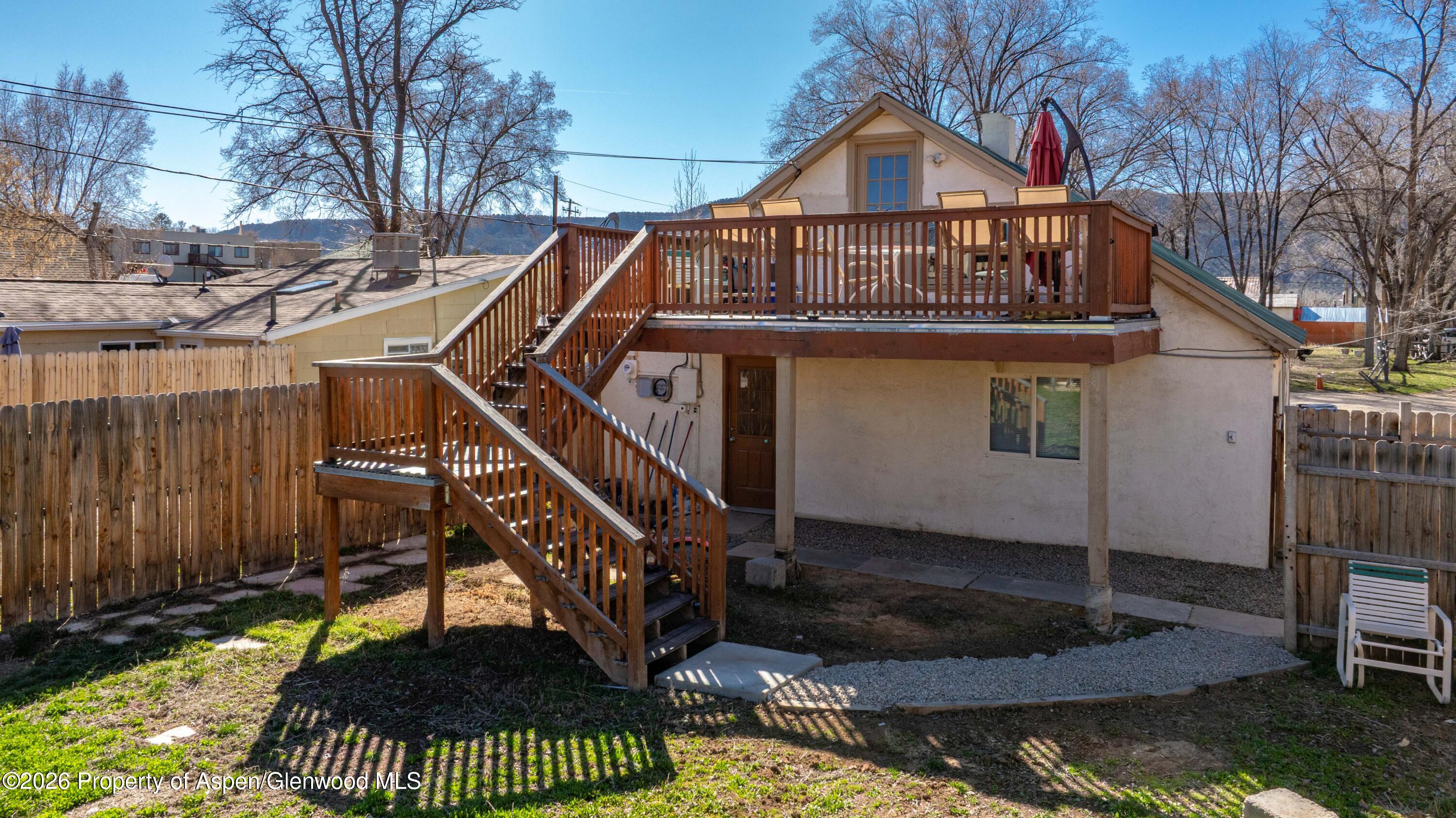 232 West 4th Street Rifle, CO 81650 - Photo 13 of 23 a view of a house with a small yard and wooden fence