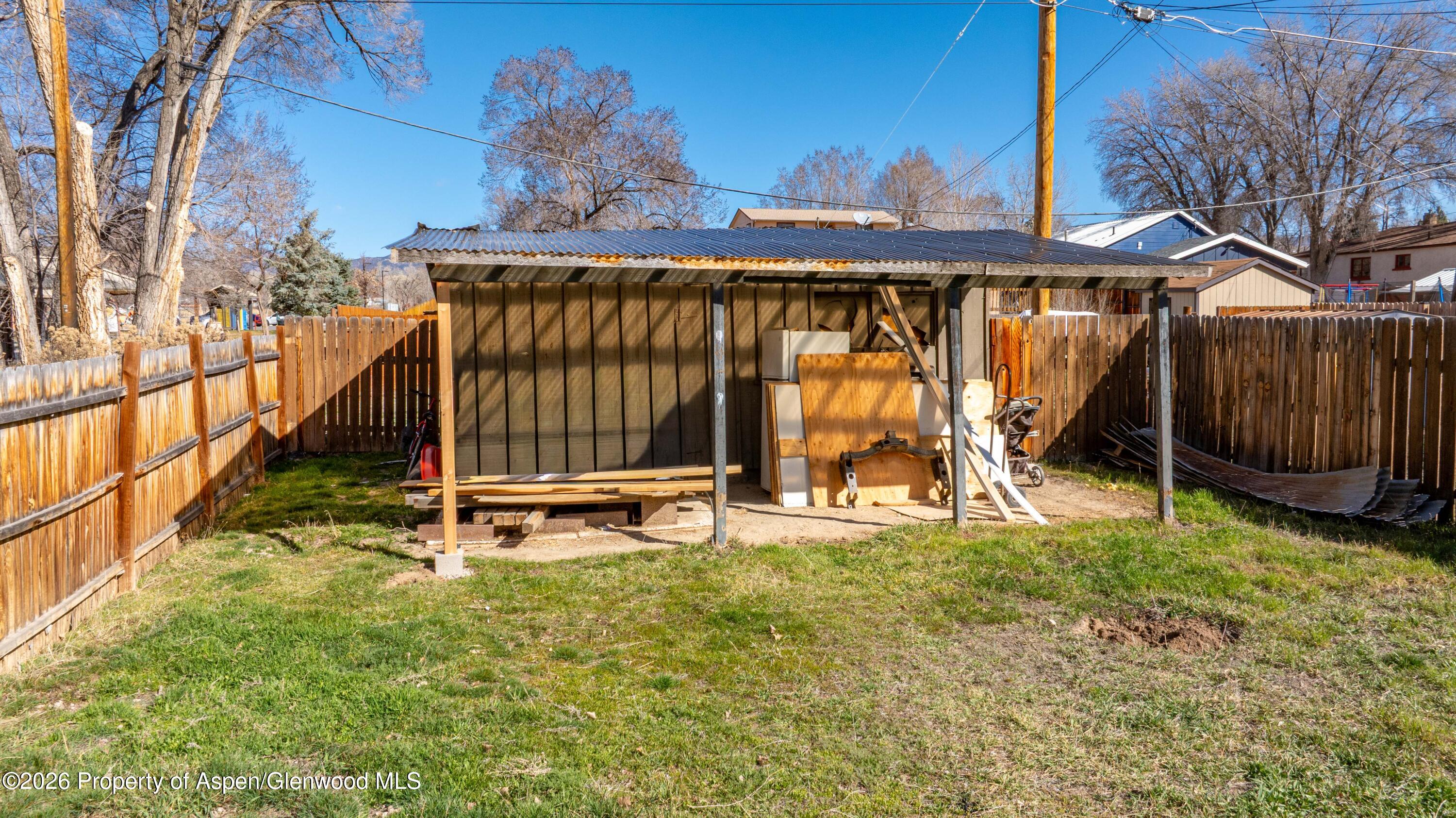 232 West 4th Street Rifle, CO 81650 - Photo 14 of 23 a view of a backyard with a wooden fence
