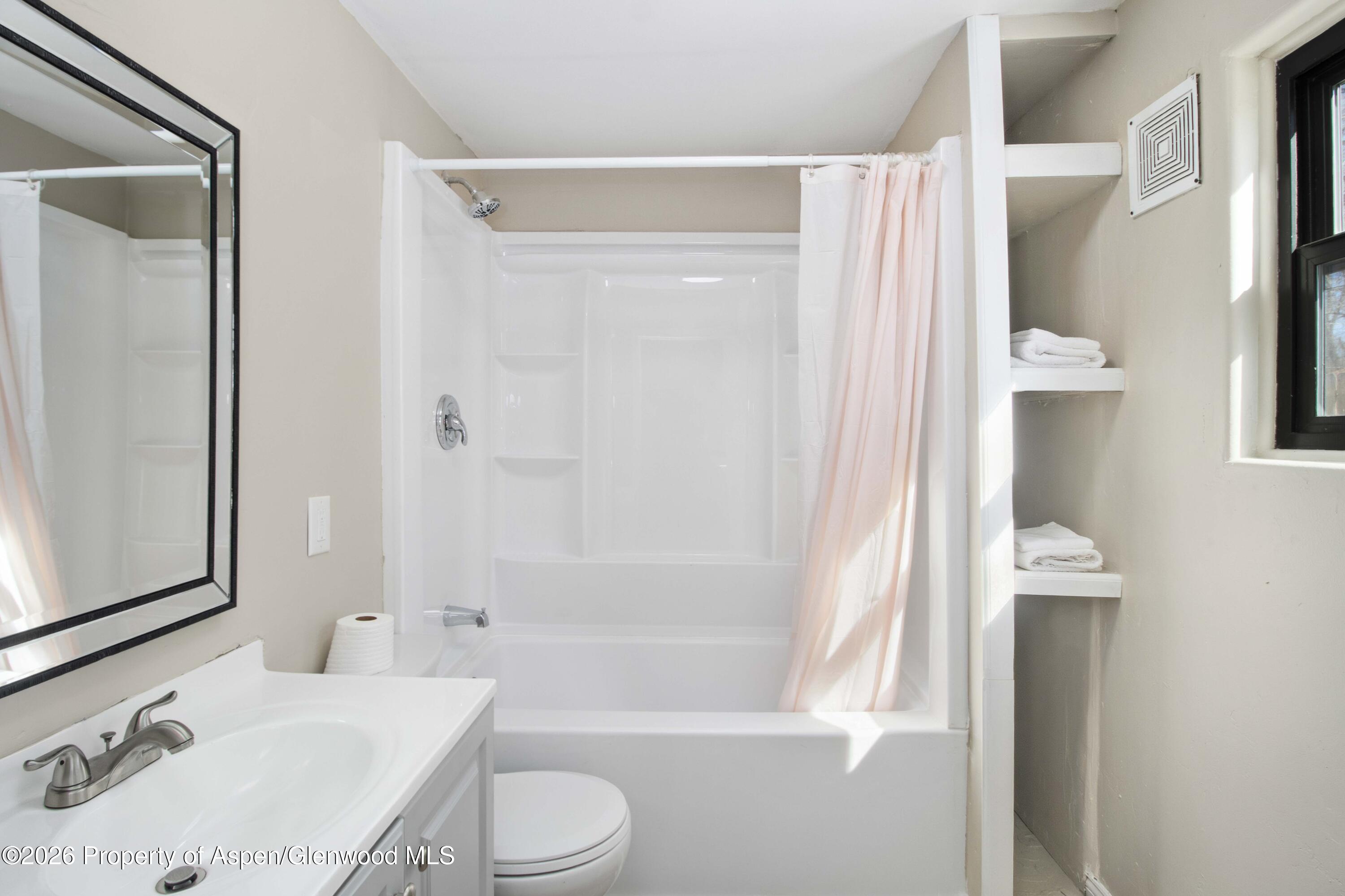 232 West 4th Street Rifle, CO 81650 - Photo 20 of 23 a bathroom with a sink toilet and shower