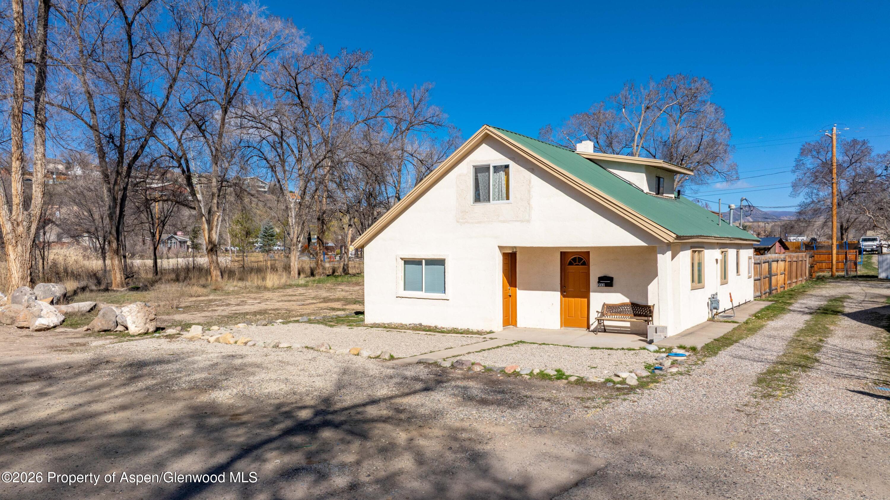 232 West 4th Street Rifle, CO 81650 - Photo 2 of 23 a front view of a house with a yard