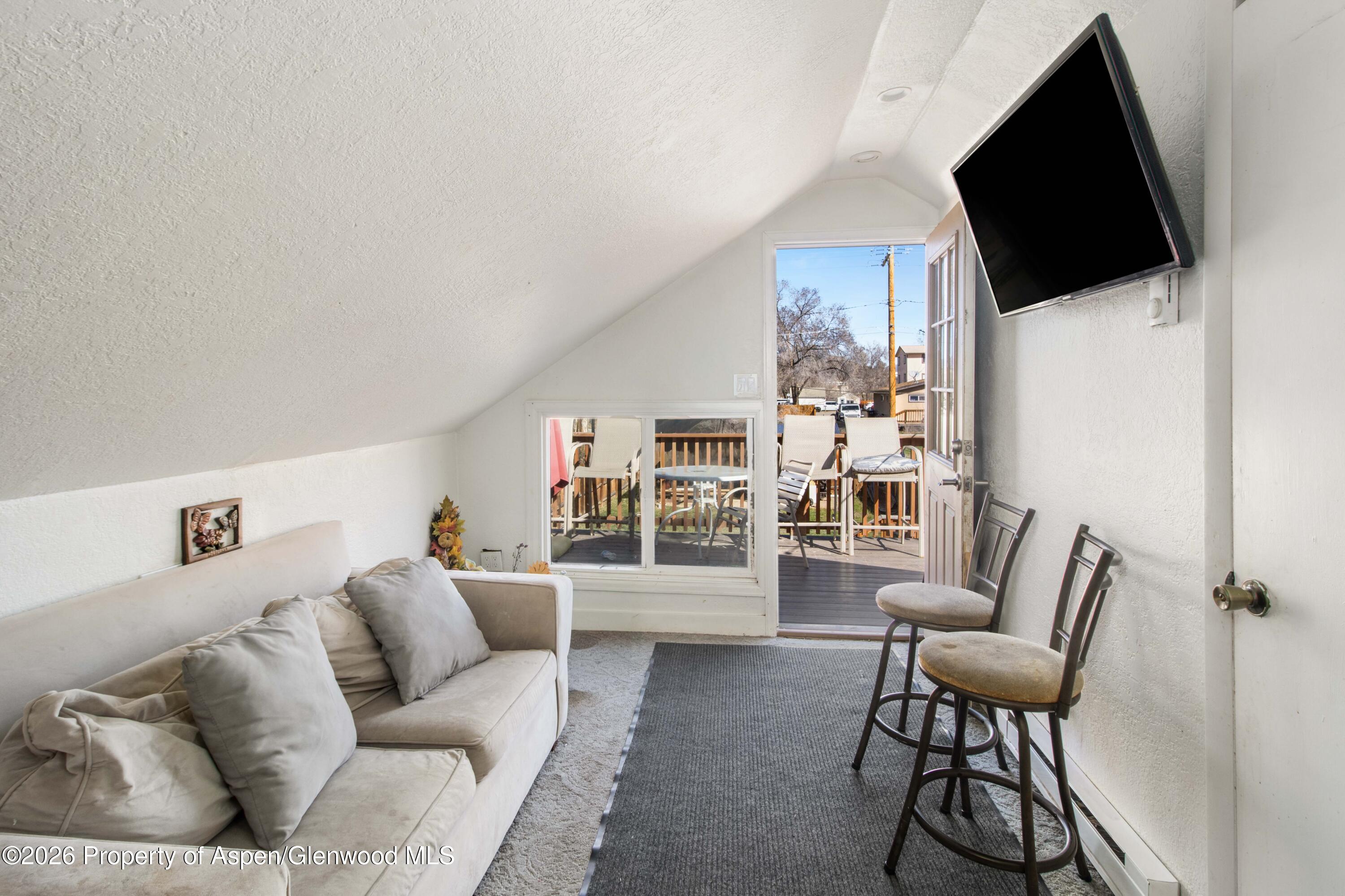 232 West 4th Street Rifle, CO 81650 - Photo 22 of 23 a living room with furniture and a flat screen tv