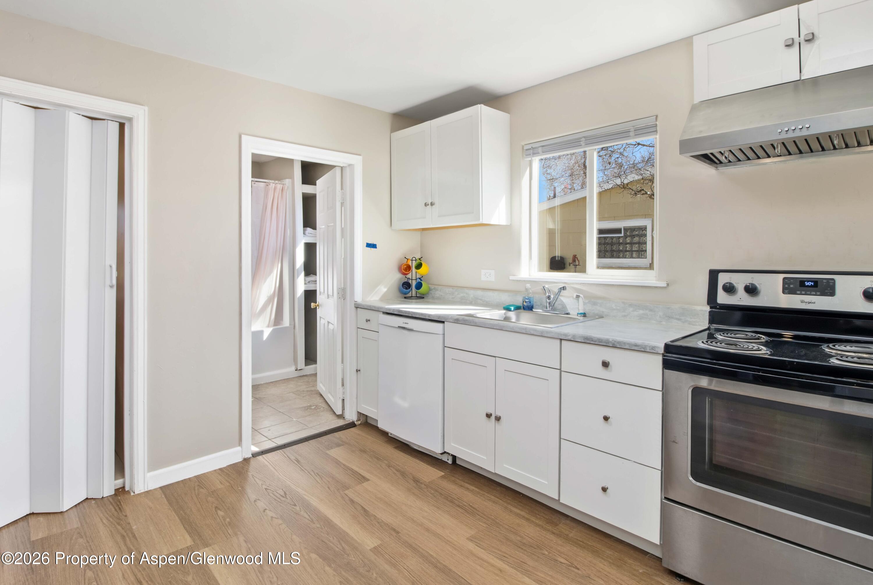 232 West 4th Street Rifle, CO 81650 - Photo 4 of 23 a kitchen with granite countertop cabinets stainless steel appliances and a window