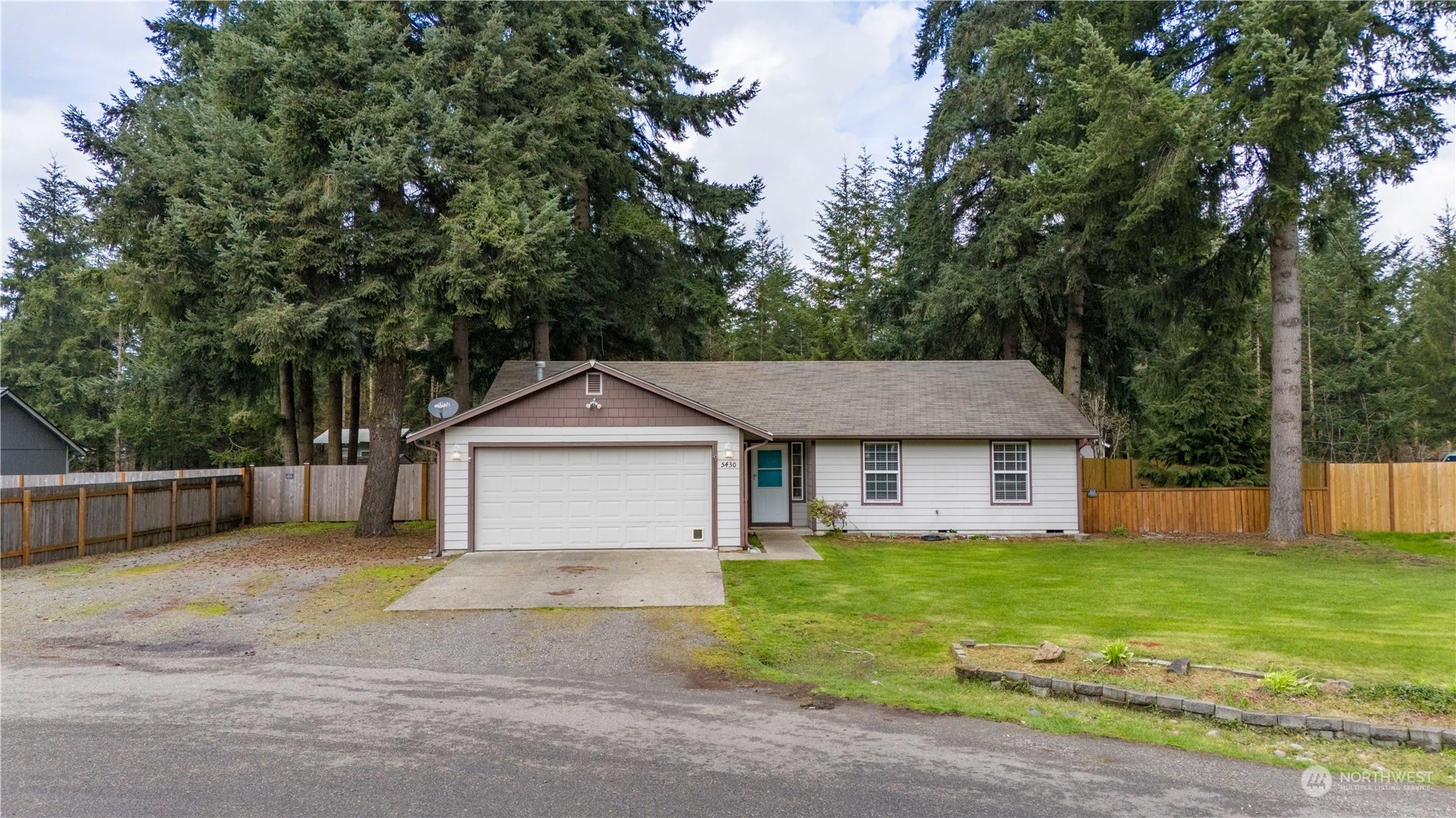 5430 187th Court Southwest Rochester, WA 98579 - Photo 1 of 34 a view of a yard in front of a house with large tree