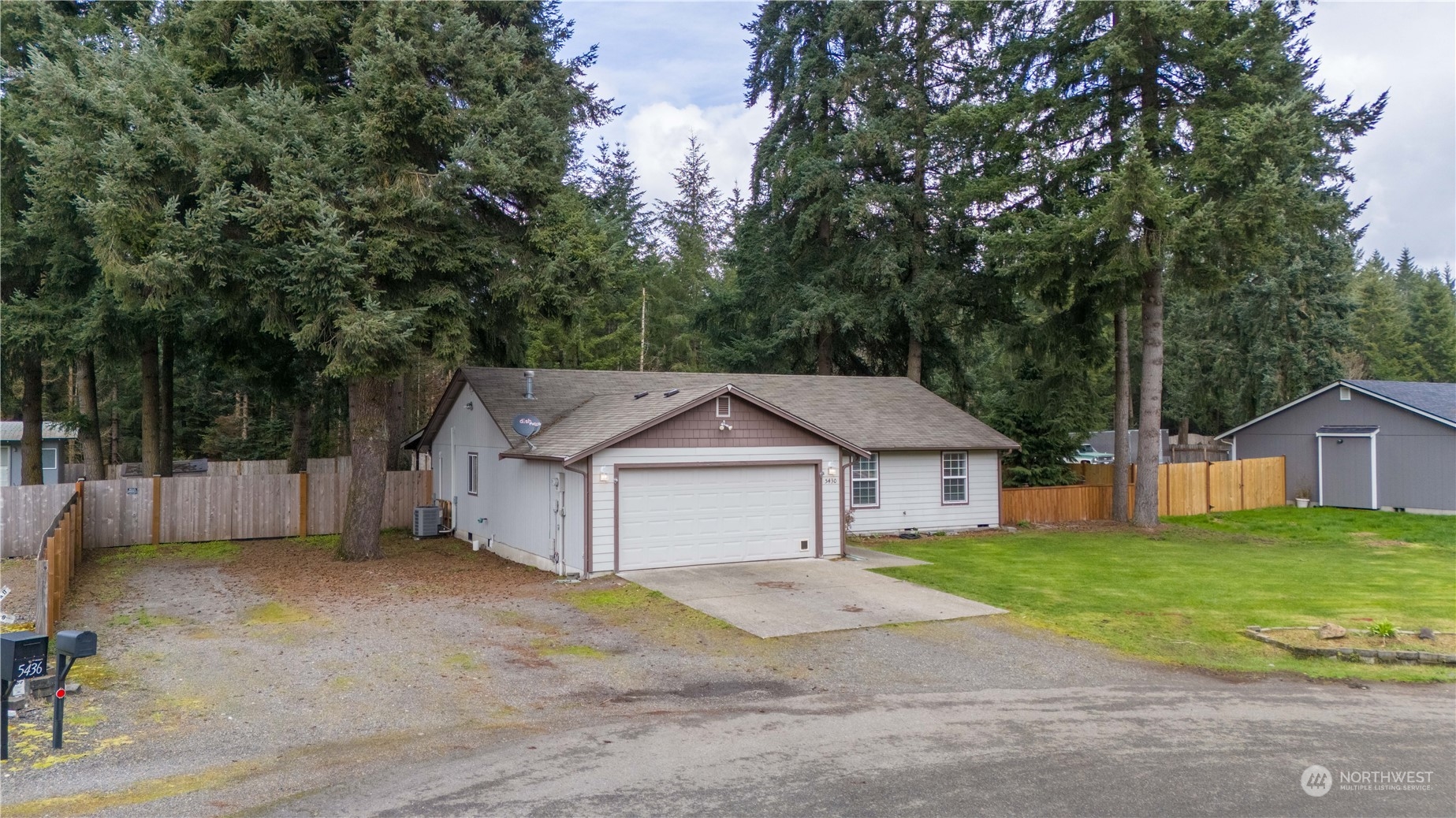 5430 187th Court Southwest Rochester, WA 98579 - Photo 3 of 34 a front view of a house with a garden and yard