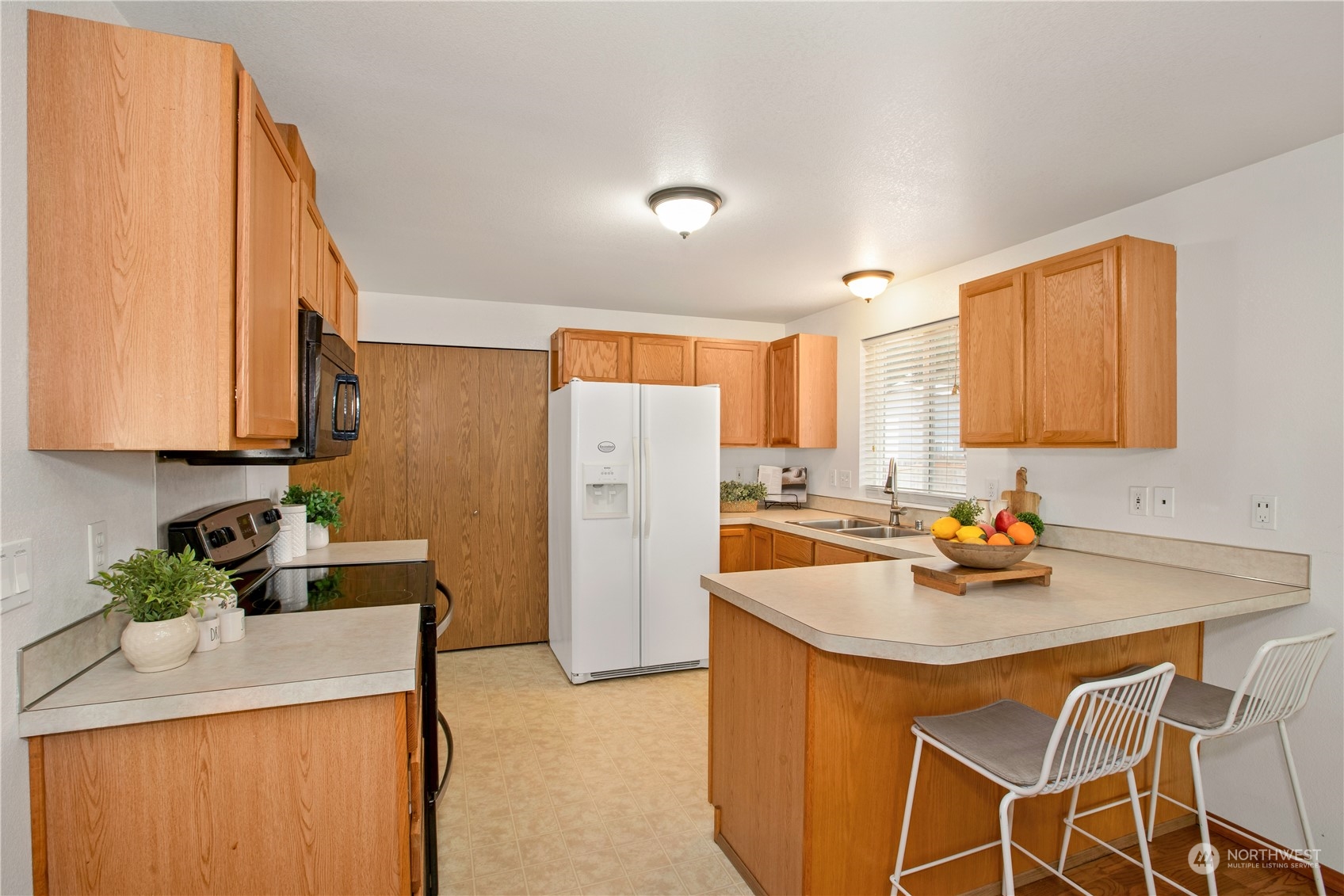5430 187th Court Southwest Rochester, WA 98579 - Photo 10 of 34 a kitchen with a sink a stove and refrigerator