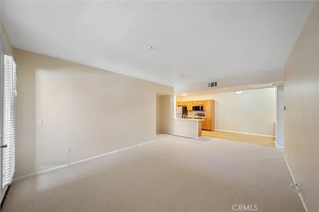 a view of empty room with a fireplace