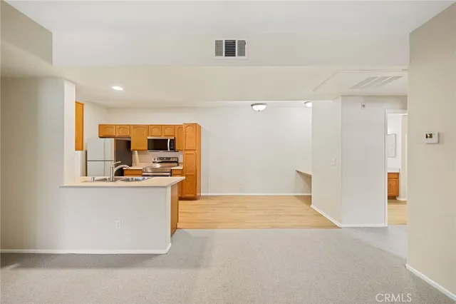 a kitchen with stainless steel appliances a refrigerator and a stove