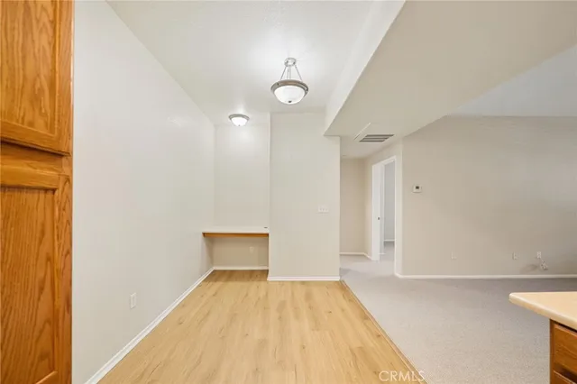 a view of a room with wooden floor and windows