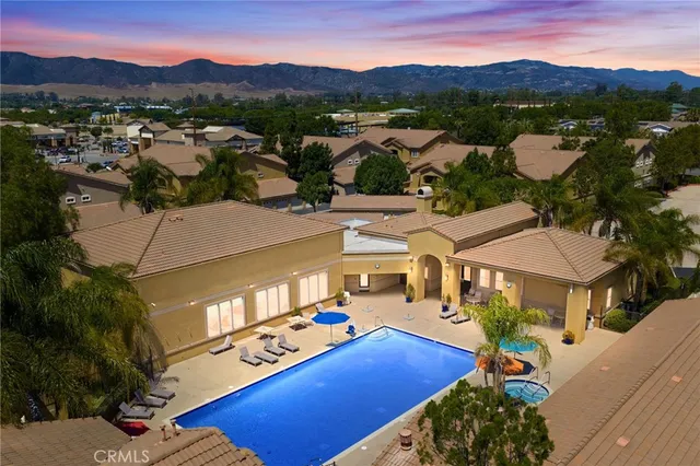 an aerial view of residential houses with outdoor space and mountain view