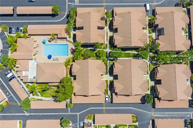 an aerial view of a house with yard swimming pool