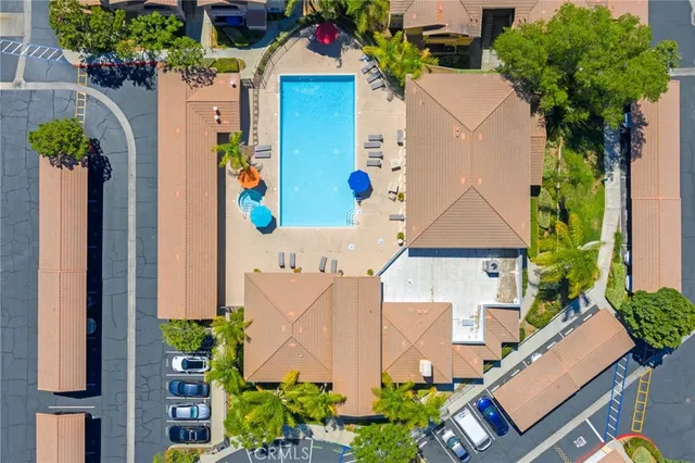 an aerial view of a house with yard and swimming pool