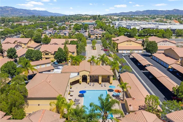 an aerial view of residential houses with outdoor space and river