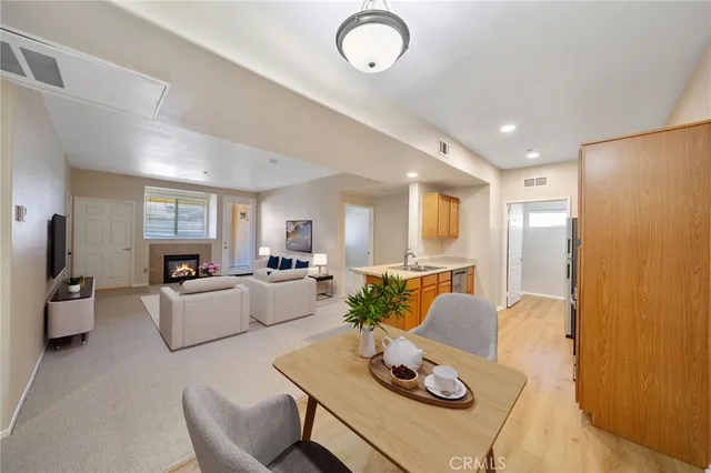 a living room with furniture kitchen view and a window