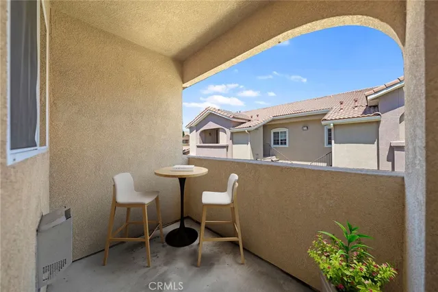 a view of backyard with a table and chairs