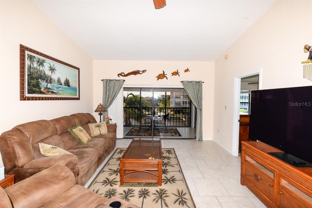 335 Coldeway Drive, Unit F21 Punta Gorda, FL 33950 - Photo 13 of 45 a living room with furniture and a flat screen tv