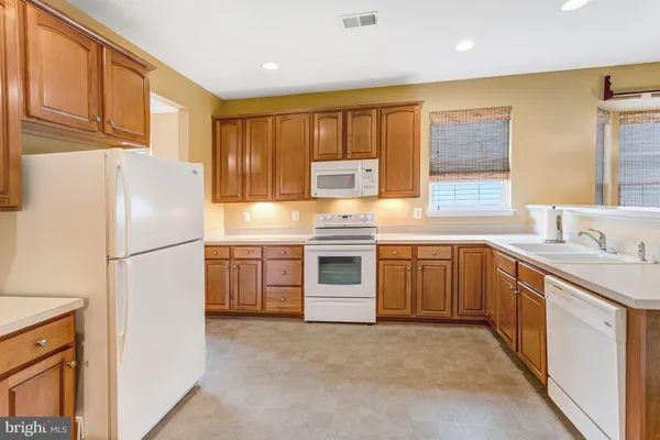 a kitchen with stainless steel appliances a refrigerator sink and cabinets