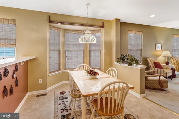 a dining room with furniture and window