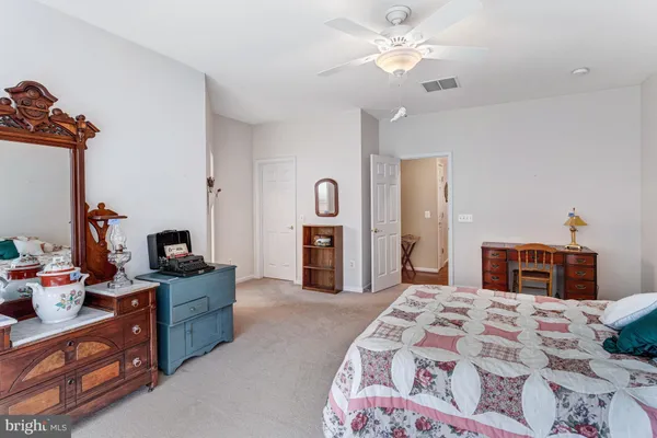 a bedroom with bed and a chandelier