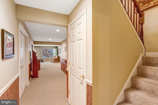 a view of a hallway with furniture and entryway