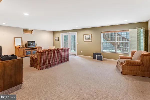 a living room with furniture window and a flat screen tv